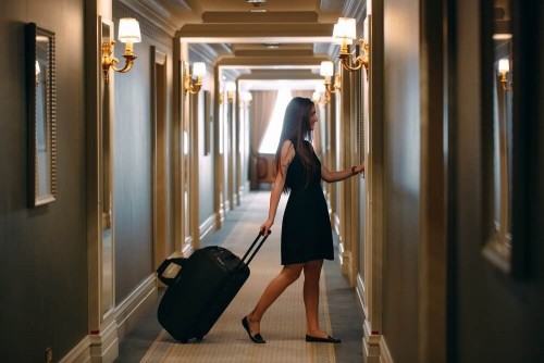 young-woman-with-handbag-suitcase-elegant-suit-walks-hotel-corridor-her-roombe6ef43e0b3f3958.jpg